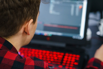 programmer coder working on his laptop. Software development. Programmer coding web application...