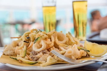 Fried mixed fish with ice-cold beer