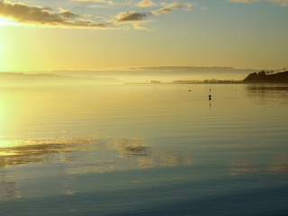 Fototapeta na wymiar beautiful landscape with morning mist above sea, blurred sea background