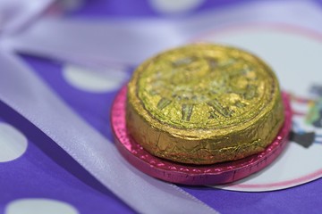 Chocolate coin in golden paper