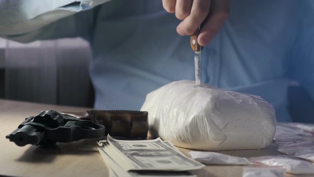 Heroin or cocaine seller with a drug package