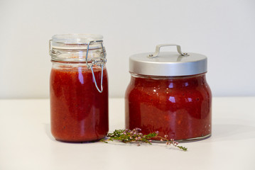 Jars of jam are on the table. Near thyme