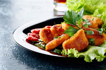  Fried chicken nuggets with ketchup, sprinkled with chopped parsley.