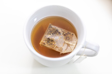 Cup of hot tea on a desk from above