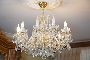 The lamp in the beautiful room .Brass chandelier with crystal. Chandelier ceiling lights ....