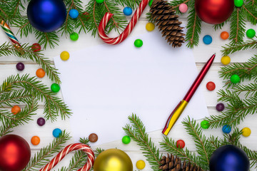 Christmas back,ground, green fir branches, red and blue, yellow, ball, candies, cone, white boards