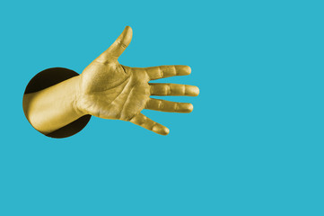 Hand painted in gold shows different gestures and symbols from the hole on a bright blue paper background