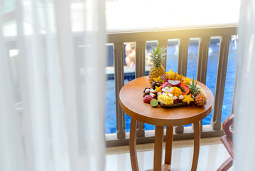 Juicy ripe tropical Thai fruits on a wooden dish.