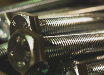 Set of metal bolts in a row background. Chromed shiny screw bolts.  Background of screw bolts,...