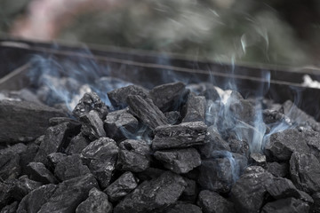 Smoke over the coals of a blacksmith's brazier