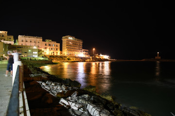 Fototapeta na wymiar Vieste Seascape by Night With Illuminated Buildings