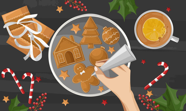 Woman hands drawing on gingerbread cookies. Gifts, berries decorations and coffee cup with orange slice on wooden table. Holiday vector