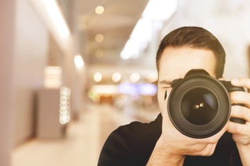 Fototapeta premium Male Photographer with Camera on black background