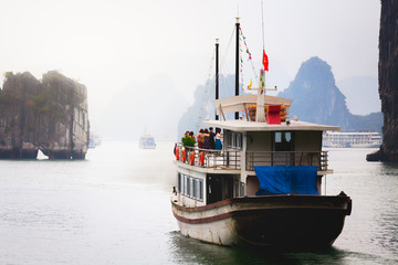 Nature Seascape Scene with Tourist Boats and Old Limestone Islets in Ha long, Quang Ninh, Vietnam
