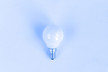 Light bulb isolated on blue tone background, concept, space for text