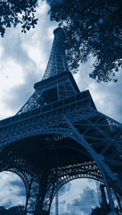 The most beautiful symbol of Paris in deep classic blue color, the Eiffel tower low angle view, blue noble color concept