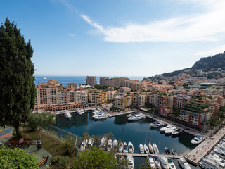 Fototapeta na wymiar Monaco, july 2019: Panoramic view of port. Azur coast. Colorful bay with a lot of luxury yachts in sunny day