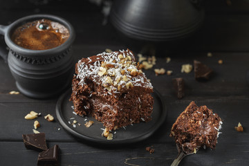 Chocolate cake in black plate on wooden table