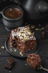 Chocolate cake in black plate on wooden table