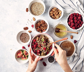Ingredients for a healthy breakfast, oatmeal with raspberries, figs, pecans, almonds, flax seeds, chia seeds with honey and coffee. Good morning, health concept. Top view