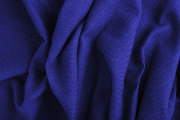 Classic blue color 2020. Texture of painted textile cloth waves. Classic blue background, blue toning 19 4052. Abstract trendy background mock up with copy space for text.