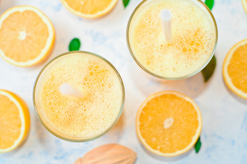 orange juice in a glass, top view, slices of oranges, straw, healthy lifestyle concept