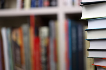 stack of books on bookshelf background, promotion of reading books