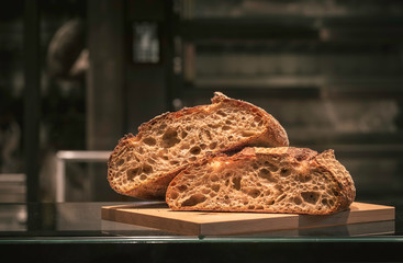 Bread halves on cutting board. Sourdough bread freshly baked