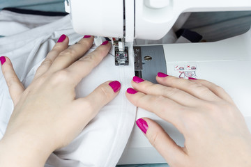 Hands on the sewing machine