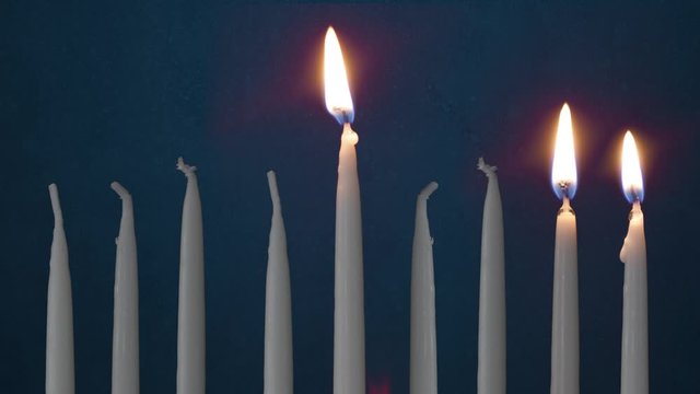 Video Of Two Lit Hanukkah Candles ON GRUNGE BACKGROUND And Shamash