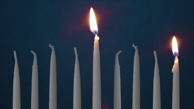 Video Of One Lit Hanukkah Candles ON GRUNGE BACKGROUND And Shamash