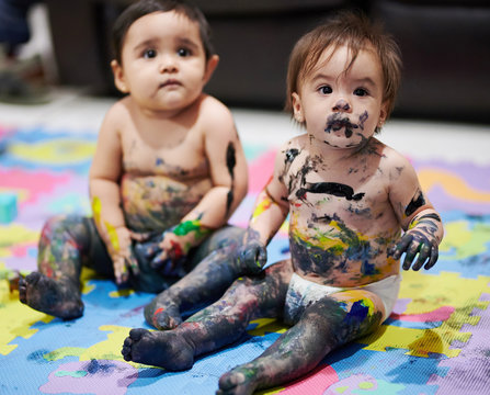 Baby girl with messy painted face