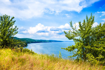 Beautiful landscape of Kaniv Reservoir, Ukraine, in sunny day with bright cloudy sky