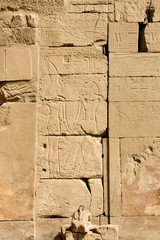 Karnak temple complex in Luxor, Egypt. Ancient bas relief with hieroglyphs, pharaoh and god.