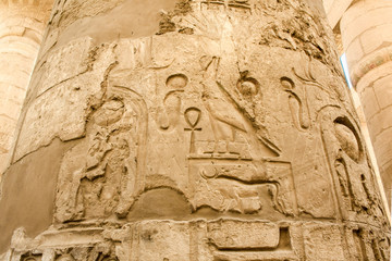 Karnak temple complex in Luxor, Egypt. Ancient bas relief with hieroglyphs on column.