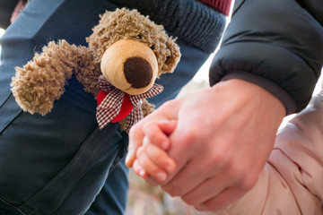 Child holding parent hand. Hands of parent and child outdoor. children psychology. Father leads her...