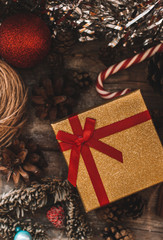 gift in Christmas decor on a wooden background