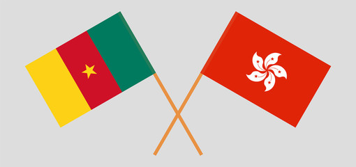 Crossed and waving flags of Cameroon and Hong Kong