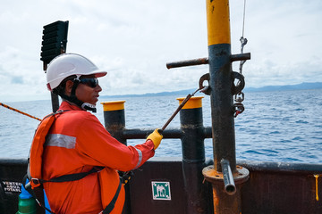 Sailor doing repairs on industrial ship