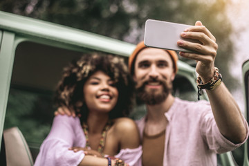 Happy hipster man and woman making selfie