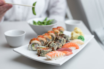 Sushi Roll Set with Seafood on White Plate. Lunch in Japanese Restaurant