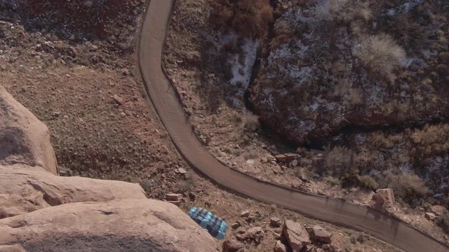 Female BASE jump double gainer off of cliff - 4k aerial