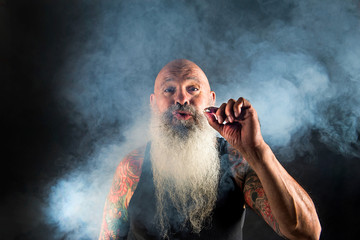 Fototapeta premium older man with beard smoking