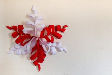 Red and white Christmas star decoration on white wall