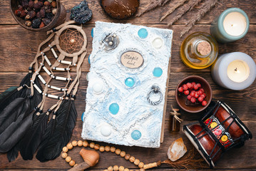 Witch doctor or shaman table flat lay background. Magic book on the witch desk.