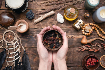 Witch doctor is preparing a magic potion on her table.