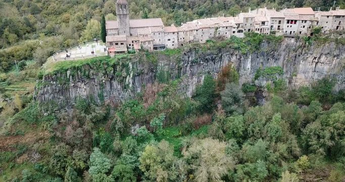 Aerial view of Castellfollit de la Roca, medieval Catalan hamlet on cliff on autumn day