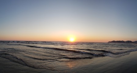 Fototapeta na wymiar sunset over the sea and waves
