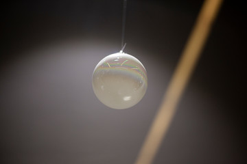 The ball is white. Decoration is one. Sphere in the air