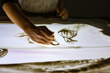 Hand sand drawing on the light table 
